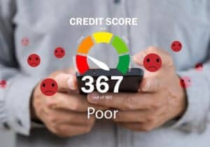 A person holding a smartphone displaying a low credit score of 367 out of 900, marked as “Poor,” with sad face icons surrounding the screen. The image represents the financial challenges faced by small businesses with low credit score when trying to access funding.
