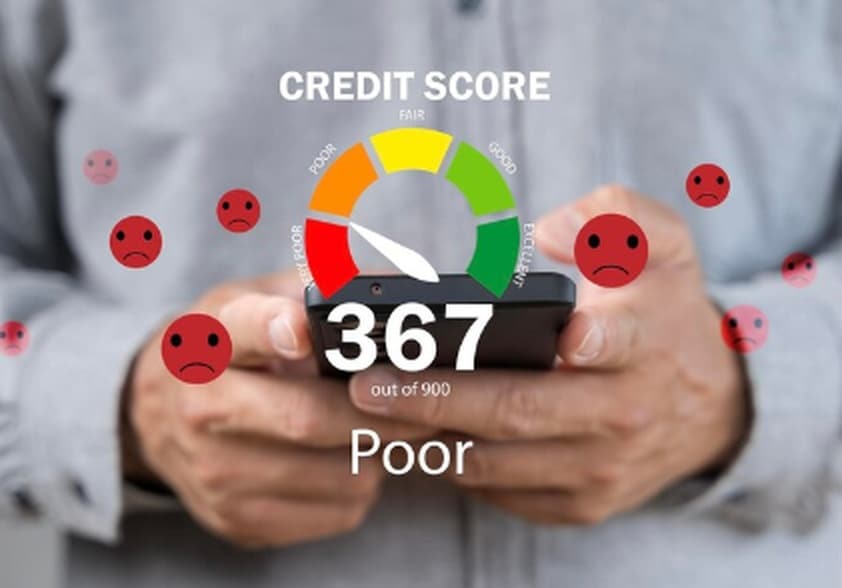 A person holding a smartphone displaying a low credit score of 367 out of 900, marked as “Poor,” with sad face icons surrounding the screen. The image represents the financial challenges faced by small businesses with low credit score when trying to access funding.