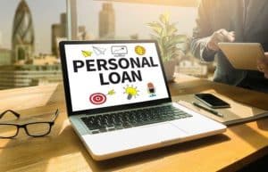 Laptop on a desk displaying the words “Personal Loan” on screen, representing the rise of fintechs for personal loans in the digital financial sector.